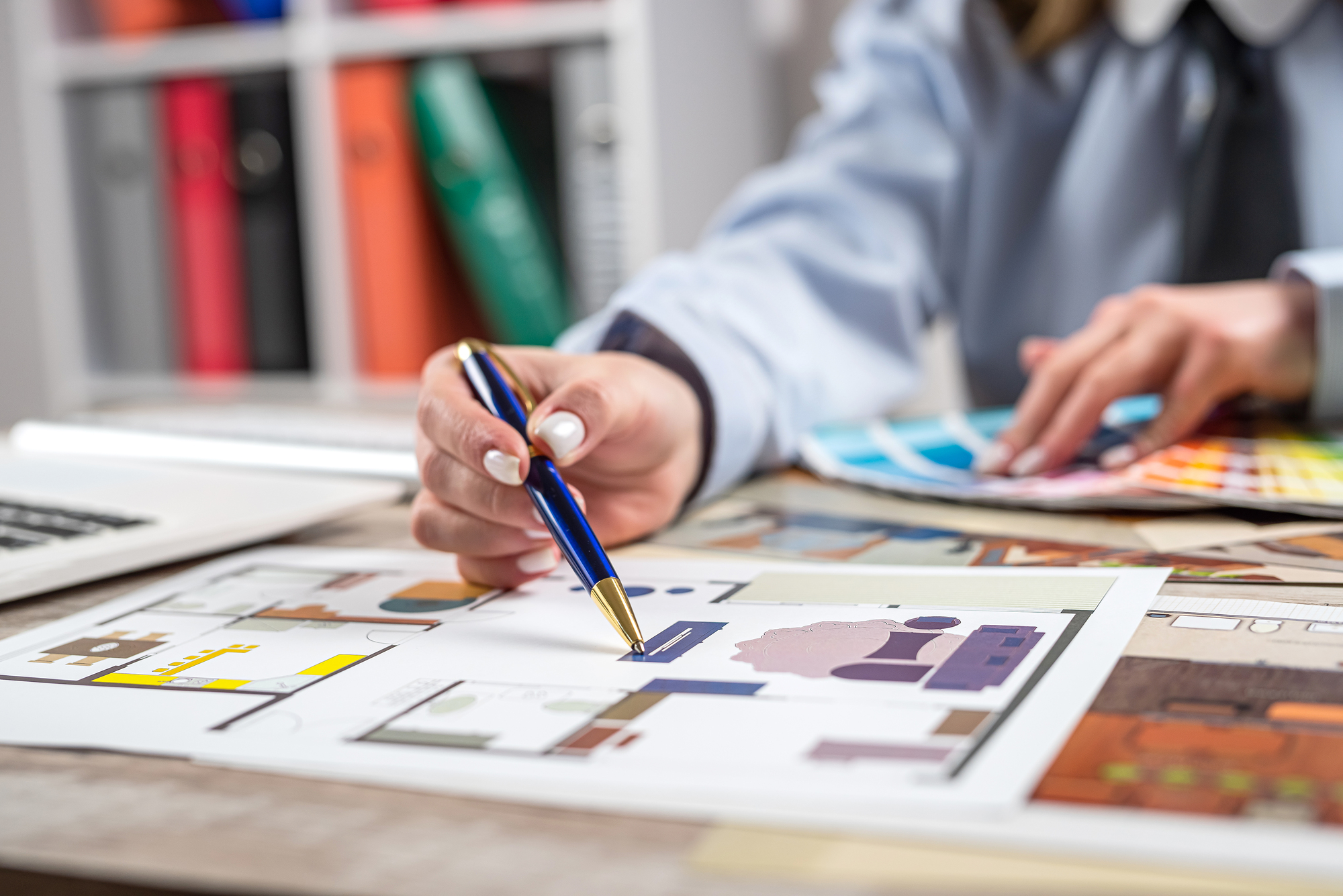 Female designer creative working choose colors for coming repairs home and sketch plan blue print
